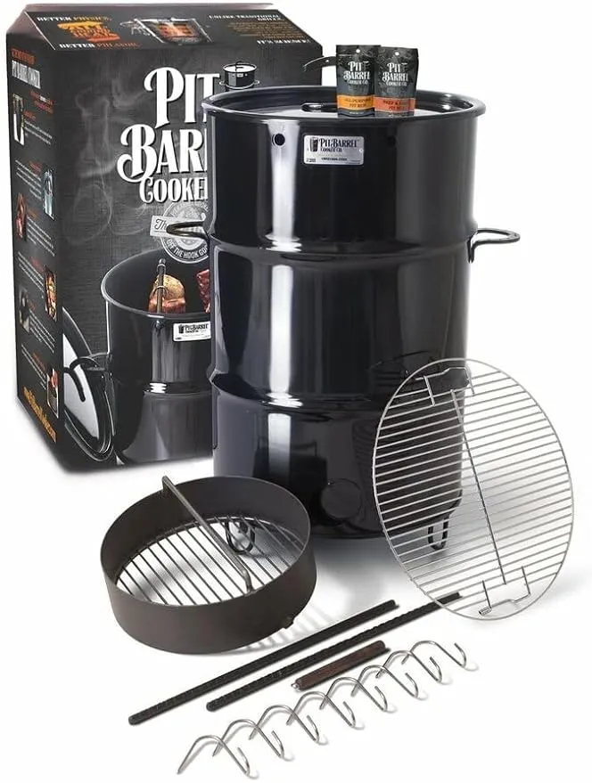 Pit-barrel-cooker Pit Barrel Cooker setup with accessories displayed, including a cooking grate, hooks, and charcoal basket, ready for outdoor grilling.