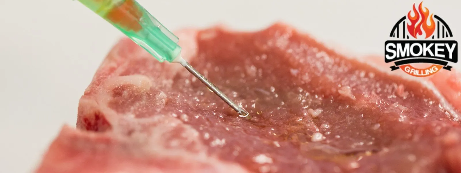 Marinade injection into a raw lamb cut to enhance flavor before smoking.