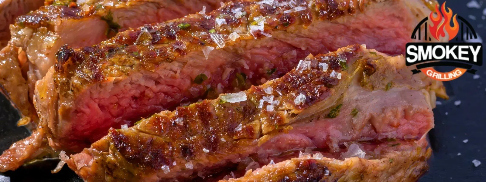 lose-up of a juicy, medium-rare steak grilled to perfection, with visible seasoning and grill marks