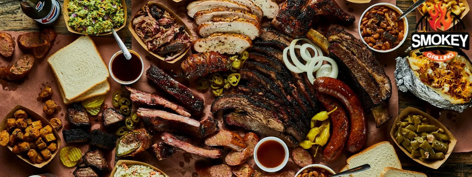 Smoked-feast-on-table Assorted smoked meats and sides spread out on a table.