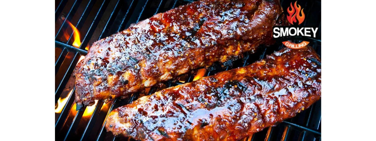 Two racks of glazed ribs grilling over an open flame.