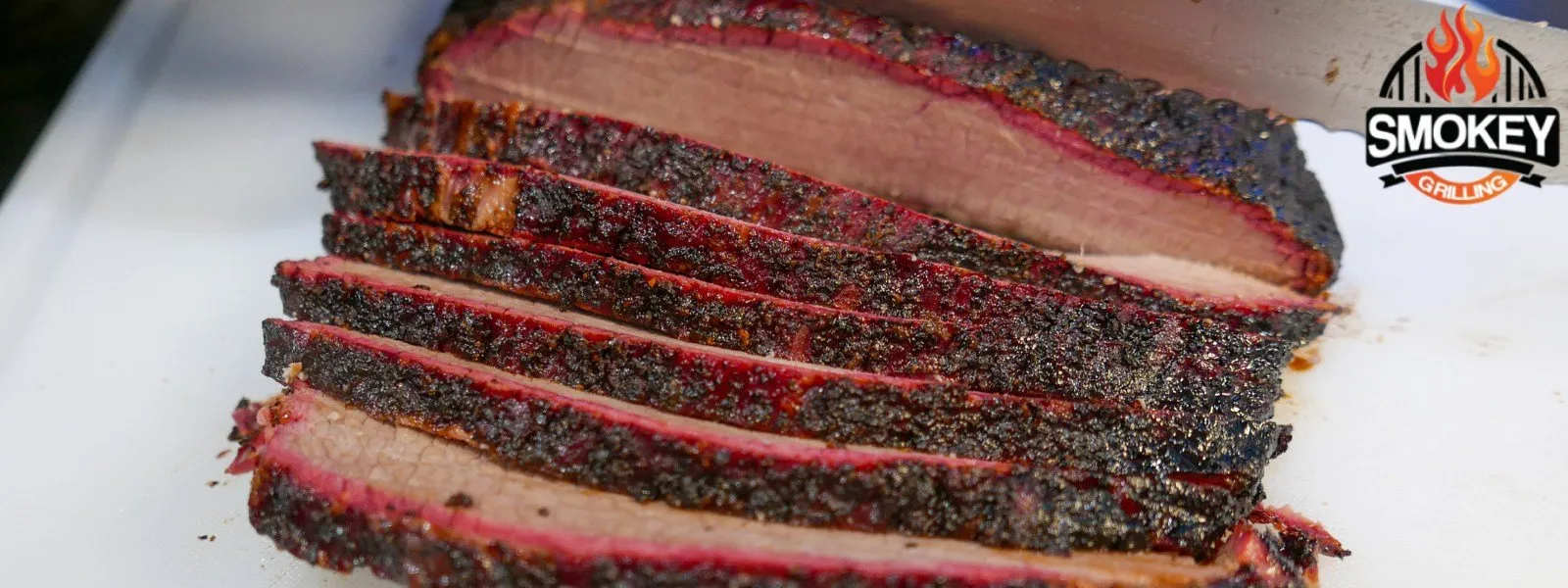 Sliced-smoked-brisket Sliced smoked brisket with a visible smoke ring.